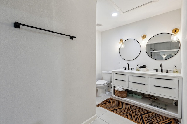 full bath with tile patterned floors, double vanity, a sink, and toilet