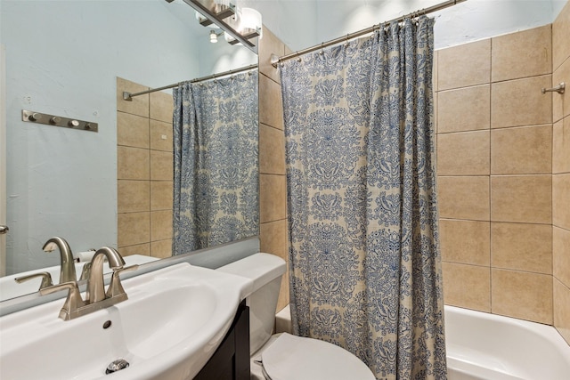 full bathroom featuring vanity, shower / tub combo with curtain, and toilet