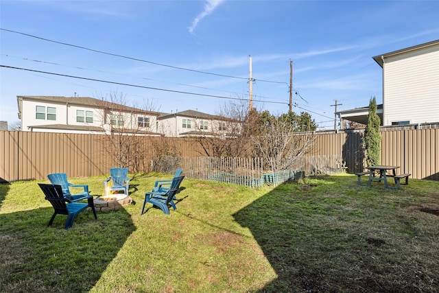 view of yard with a fire pit and a fenced backyard