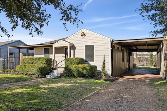 view of front of home featuring a front lawn and a carport