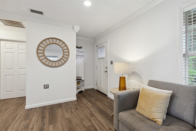 living area featuring crown molding, dark wood finished floors, baseboards, and visible vents