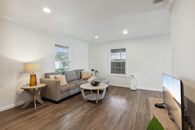 living room featuring crown molding, dark wood-type flooring, and baseboards