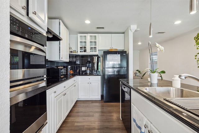 kitchen featuring dark countertops, white cabinets, black appliances, and glass insert cabinets