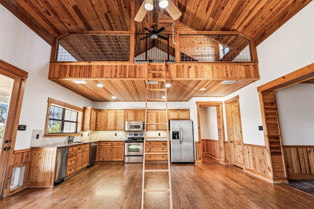 kitchen featuring high vaulted ceiling, wooden ceiling, and appliances with stainless steel finishes