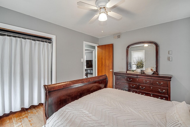 bedroom with ceiling fan and light hardwood / wood-style floors