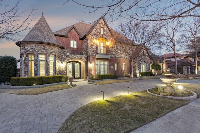 view of front of property with a lawn and french doors