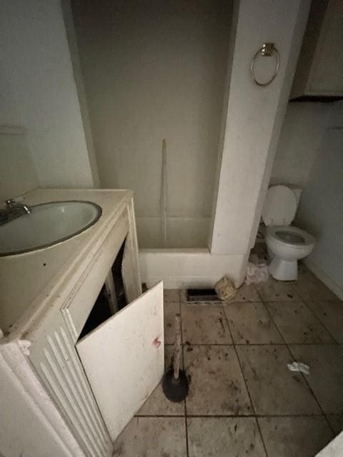 bathroom featuring toilet, vanity, and tile patterned floors