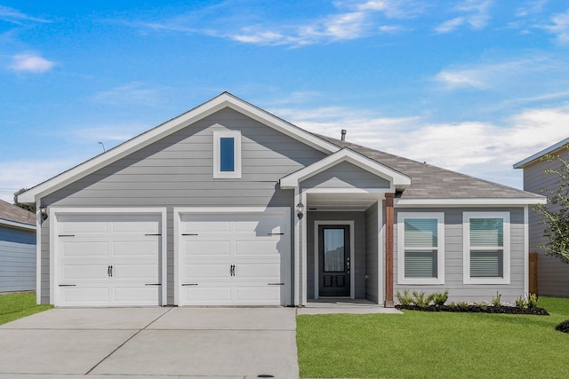 view of front of home with a front lawn and a garage