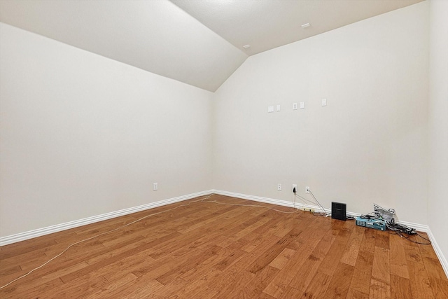 interior space with wood-type flooring and vaulted ceiling