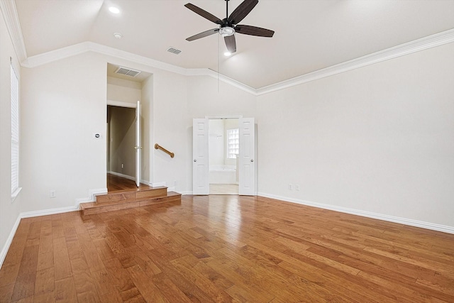 unfurnished room with ceiling fan, vaulted ceiling, crown molding, and hardwood / wood-style flooring