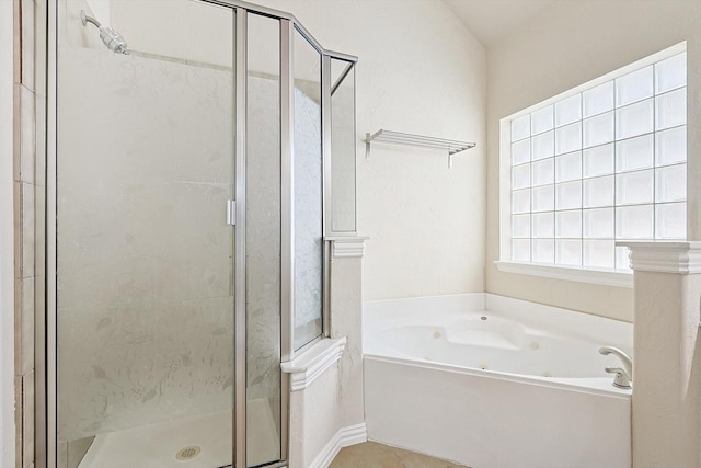 bathroom with independent shower and bath and tile patterned flooring