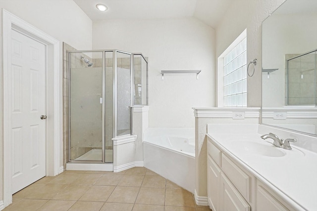 bathroom with vaulted ceiling, tile patterned floors, separate shower and tub, and vanity