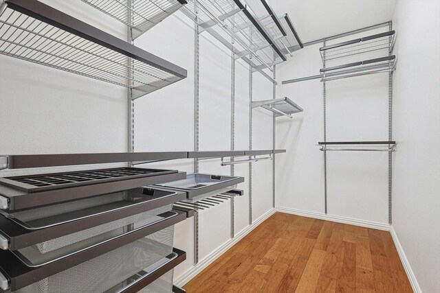 walk in closet featuring light hardwood / wood-style flooring