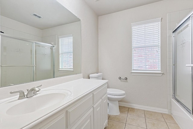 full bathroom with tile patterned floors, toilet, vanity, and shower / bath combination with glass door