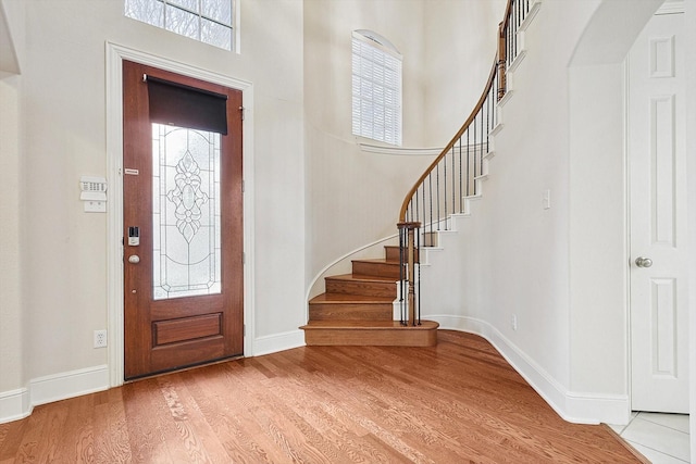 foyer entrance featuring light wood-type flooring and plenty of natural light