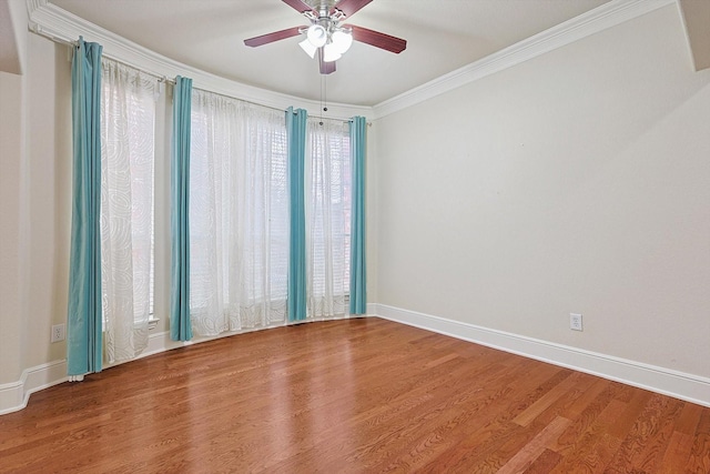 empty room with ceiling fan, hardwood / wood-style floors, and ornamental molding