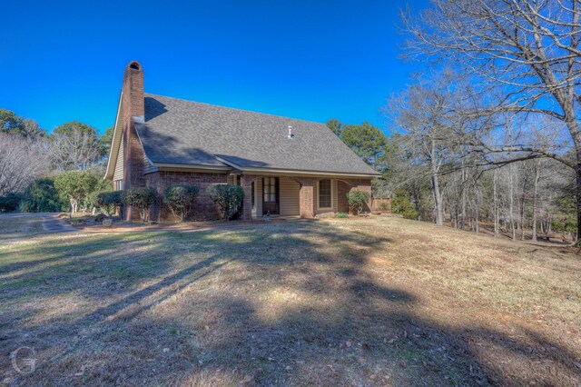 back of house with a yard