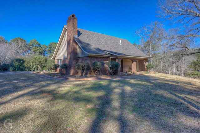 rear view of house with a yard