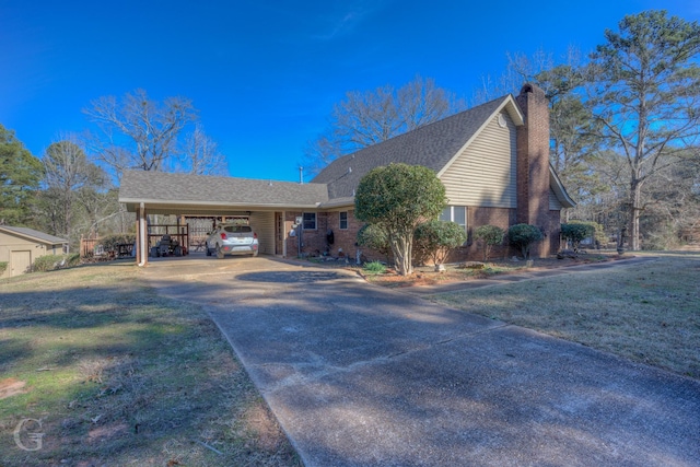 view of front of house with a front lawn and a carport