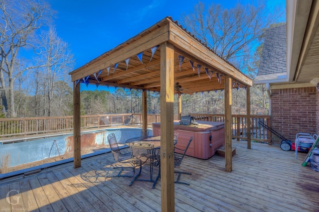 wooden deck with a hot tub