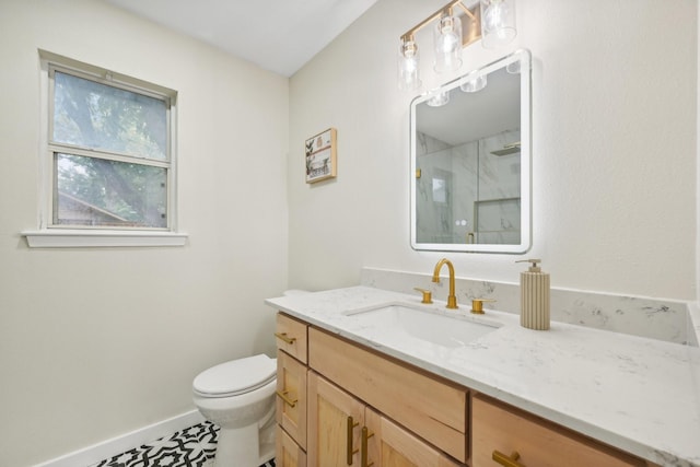 bathroom featuring vanity, toilet, and walk in shower