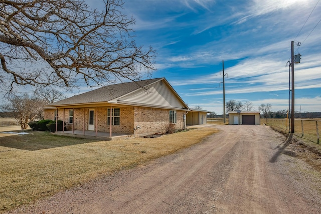 view of property exterior with a garage, a lawn, and an outdoor structure