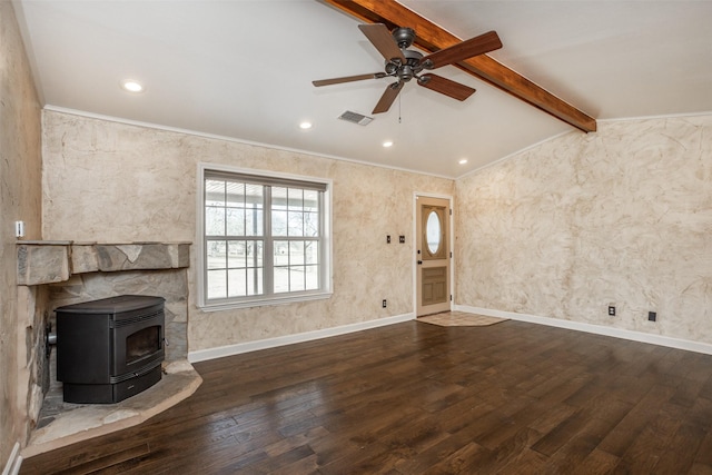 unfurnished living room with ceiling fan, a wood stove, dark hardwood / wood-style flooring, and lofted ceiling with beams