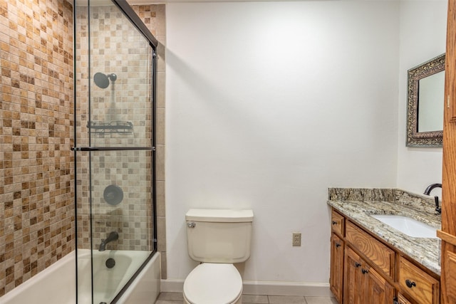 368 Hawkins Rd, Whitesboro, TX 76273 - full bathroom featuring tile patterned flooring, baseboards, vanity, enclosed tub / shower combo, and toilet