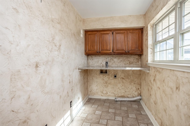 washroom with hookup for a washing machine, electric dryer hookup, and cabinets