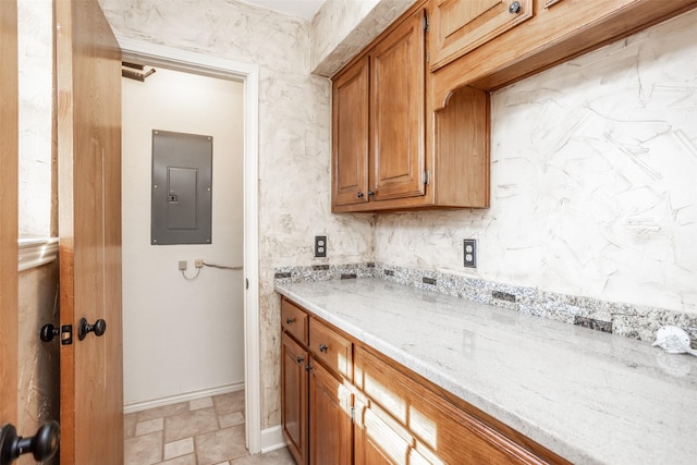 kitchen with light stone countertops and electric panel