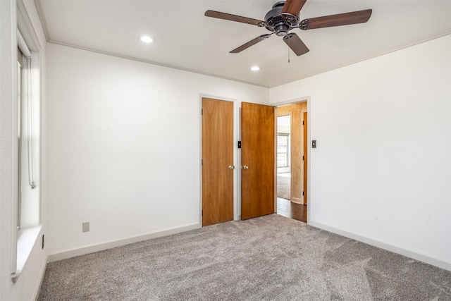 unfurnished bedroom with ceiling fan, carpet flooring, and ornamental molding