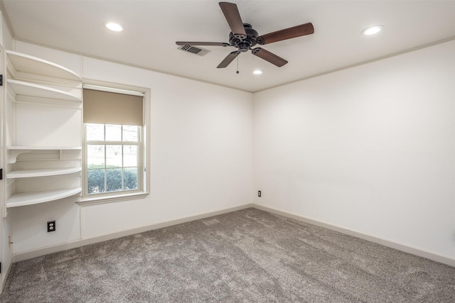 empty room with ceiling fan, carpet, and crown molding