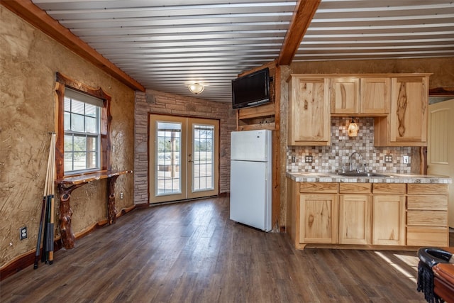 kitchen with white fridge, light brown cabinetry, french doors, beam ceiling, and sink