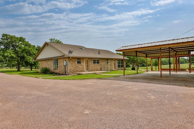 368 Hawkins Rd, Whitesboro, TX 76273 - view of front of house with brick siding, a carport, and a front lawn
