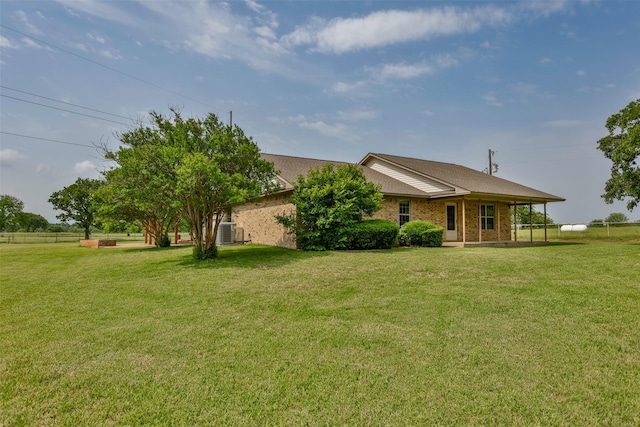 368 Hawkins Rd, Whitesboro, TX 76273 - view of front facade with a front yard, central air condition unit, and brick siding