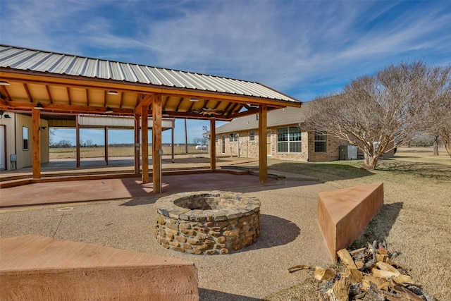 view of patio / terrace featuring an outdoor fire pit