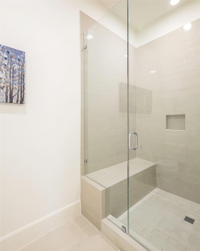 bathroom featuring tile patterned flooring and a shower with door