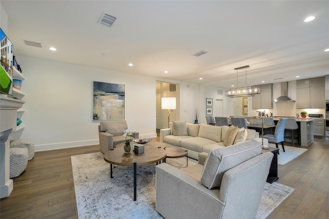 living room featuring dark hardwood / wood-style floors and a notable chandelier