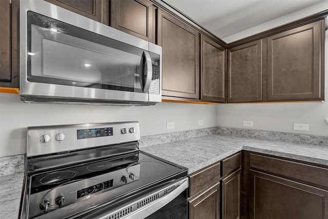 kitchen with dark brown cabinets and stainless steel appliances