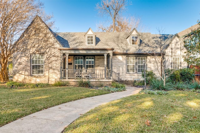 view of front of house with a porch and a front yard