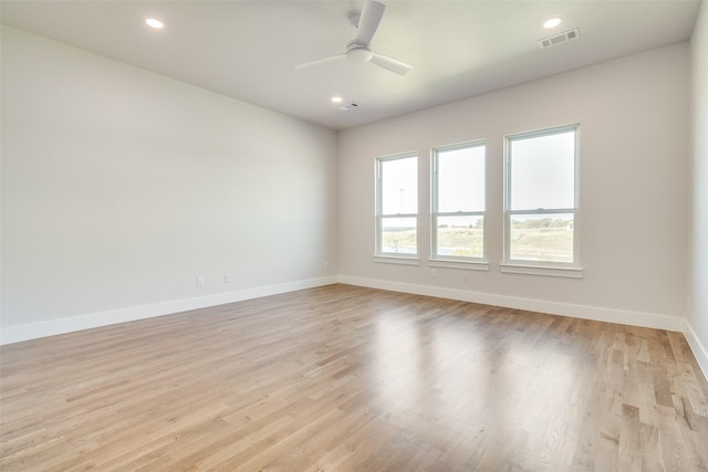 empty room with ceiling fan and light wood-type flooring