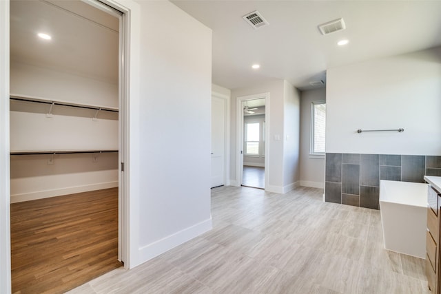 bathroom with ceiling fan, wood-type flooring, and vanity