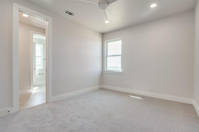 carpeted spare room with ceiling fan