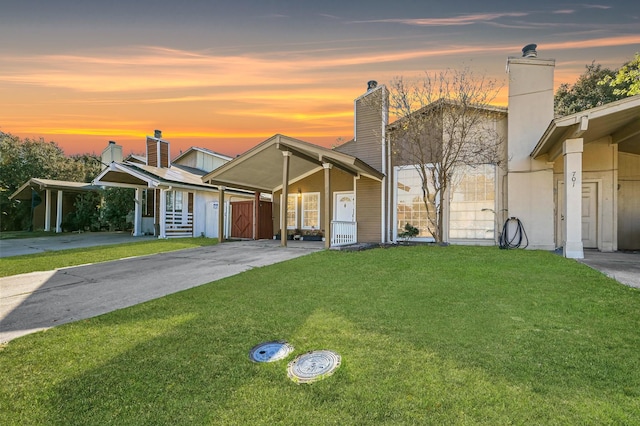 view of front facade with a carport and a yard