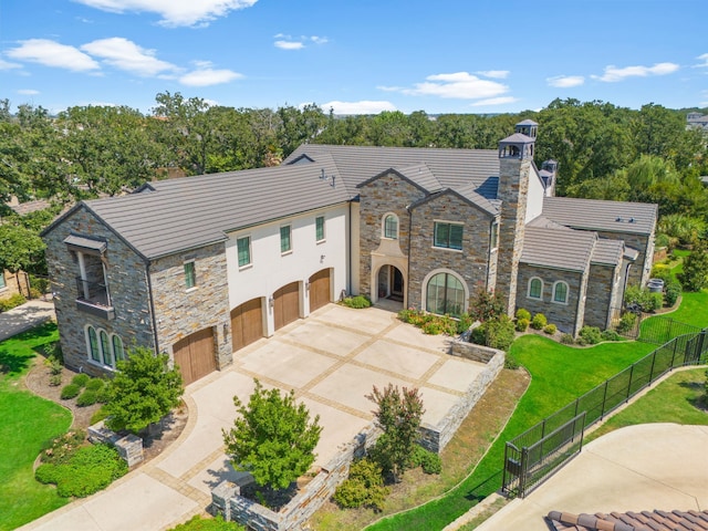 view of front of house featuring a garage and a front lawn