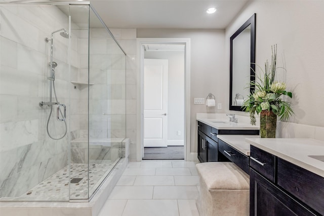 bathroom featuring an enclosed shower, vanity, and tile patterned flooring