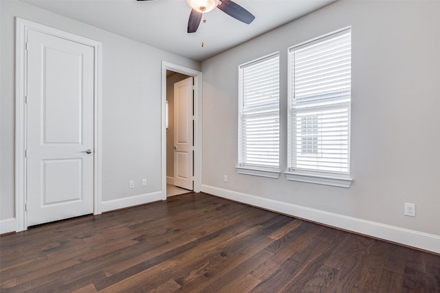 unfurnished bedroom featuring ceiling fan and dark hardwood / wood-style floors