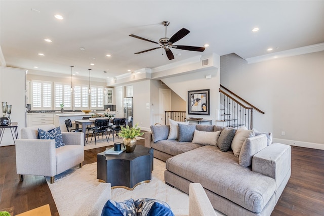 living room with ceiling fan, crown molding, and hardwood / wood-style floors