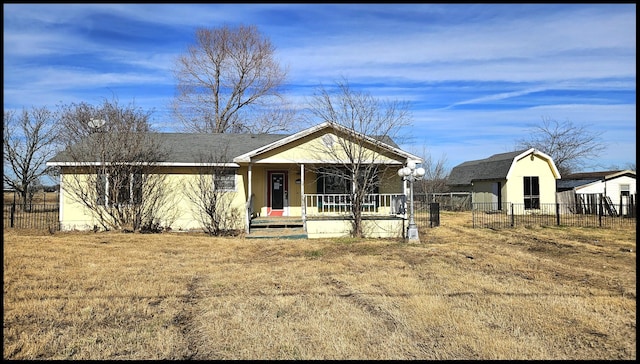 view of front of home featuring covered porch and a front yard