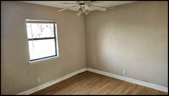 empty room featuring ceiling fan and hardwood / wood-style floors